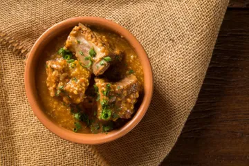 Un cuenco con canjiquinha braseileña, costillas en salsa.