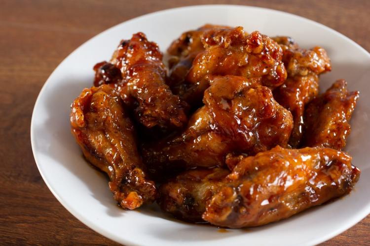 Un plato con alitas de pollo glaseadas.
